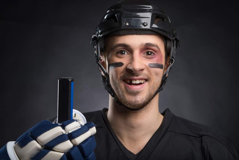 Funny hockey player smiling with one tooth missing